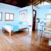 A bedroom with wood floors and white walls.
