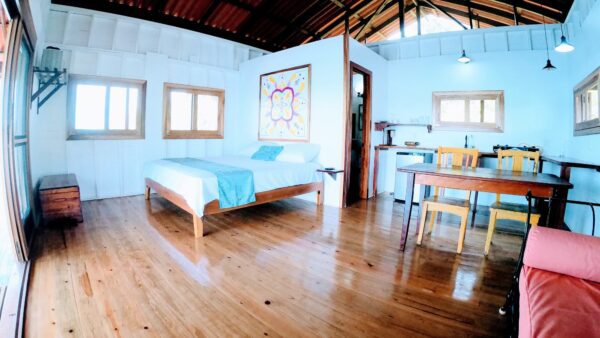 A bedroom with wood floors and white walls.