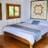 A bed room with a large painting on the wall