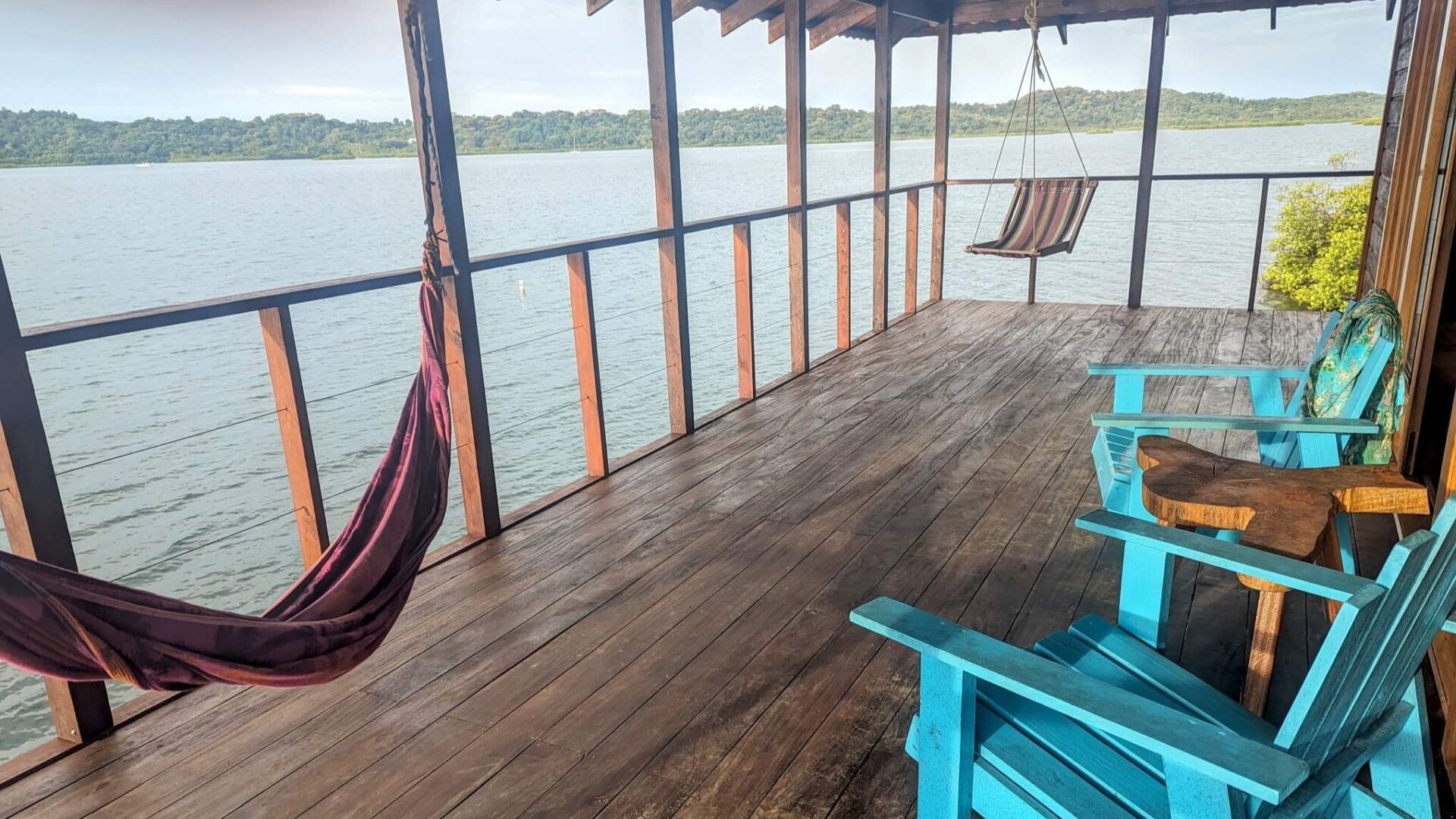 A deck with chairs and hammocks on it